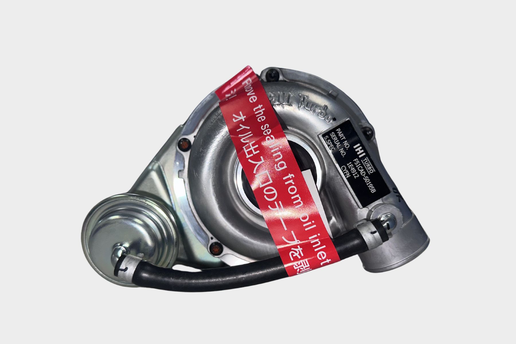 The F51CAD-S0195B IHI Turbocharger CYFN, made of metal with a red warning tag and an attached black hose, is displayed against a plain white background.